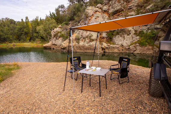 Camping chairs and table under gazebo